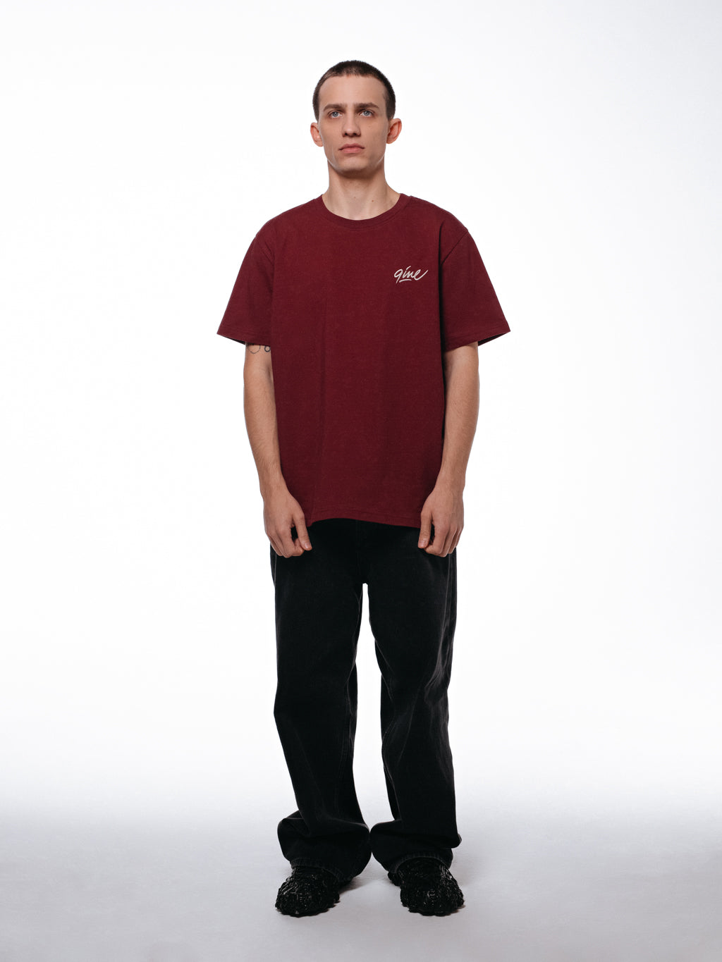 Front of the maroon Signature t-shirt by 9INE viewed on a model.