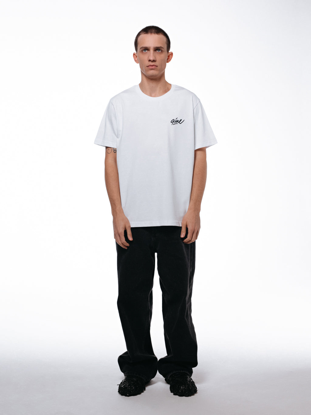 Front of the white Signature t-shirt by 9INE viewed on a model.