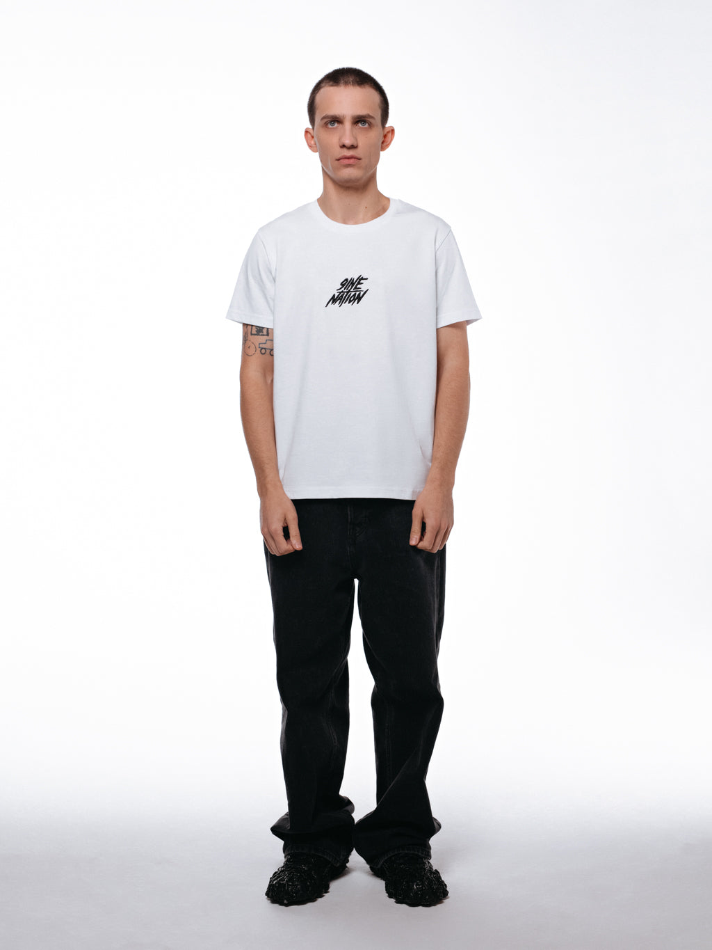 Front of the white core collection t-shirt by 9INE viewed on a model.