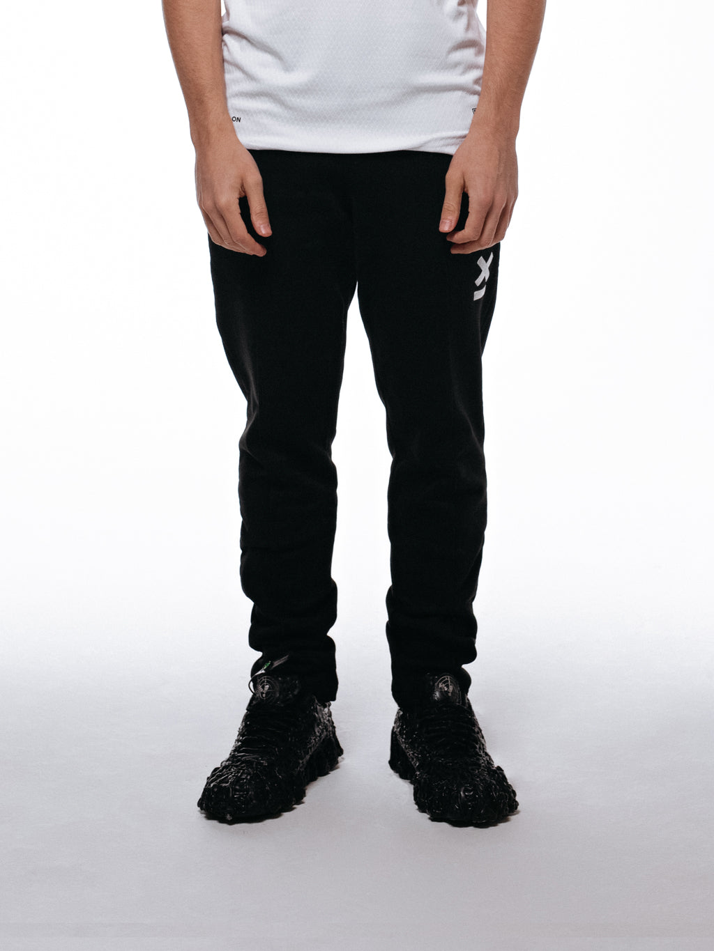 Side of joggers by 9INE viewed on a model.